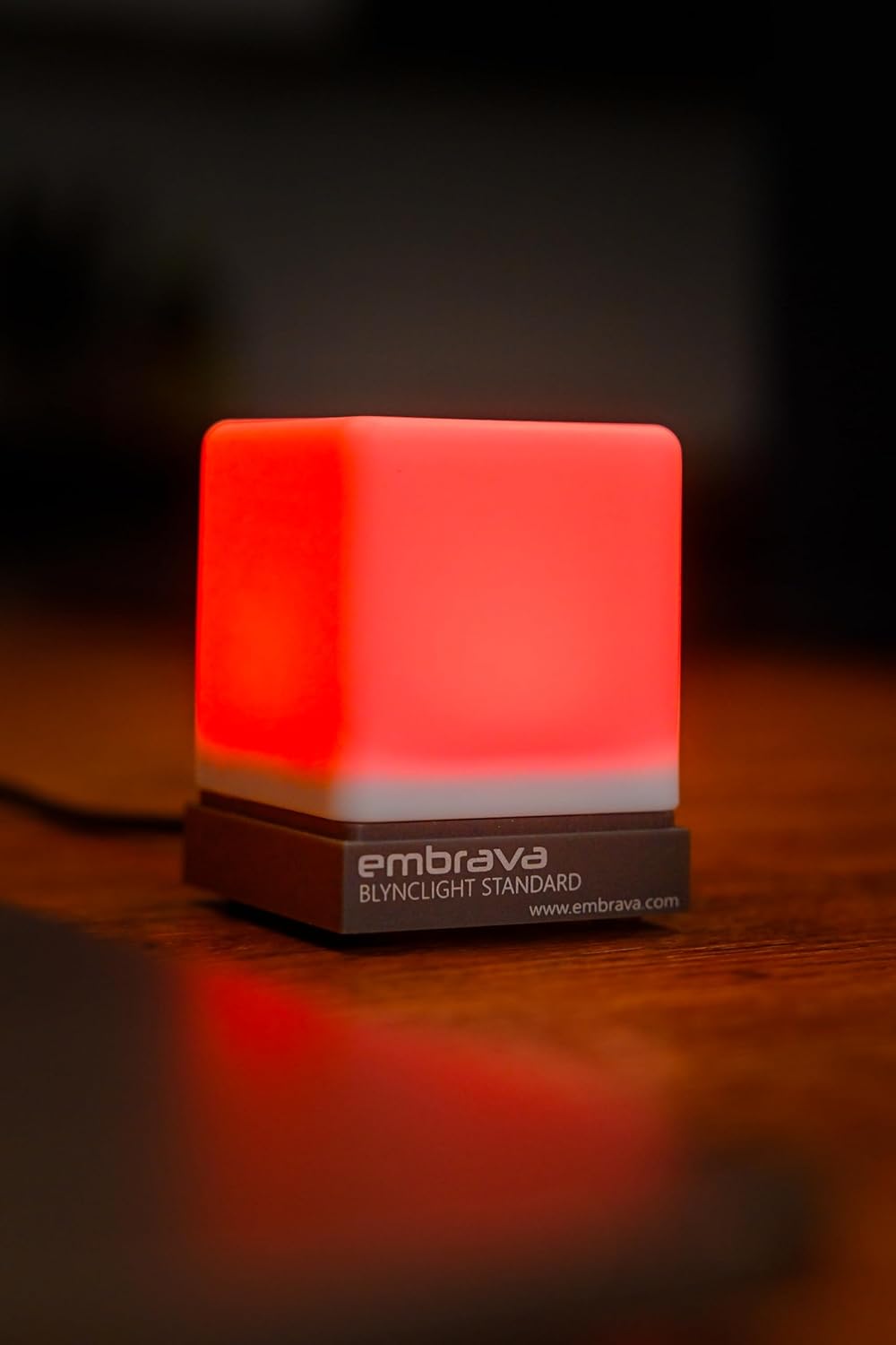 Embrava Blynclight on a monitor, glowing green in a busy office
