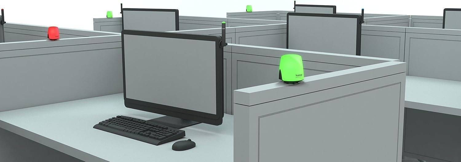 Kuando Busylight UC Omega on desk in office cubicle