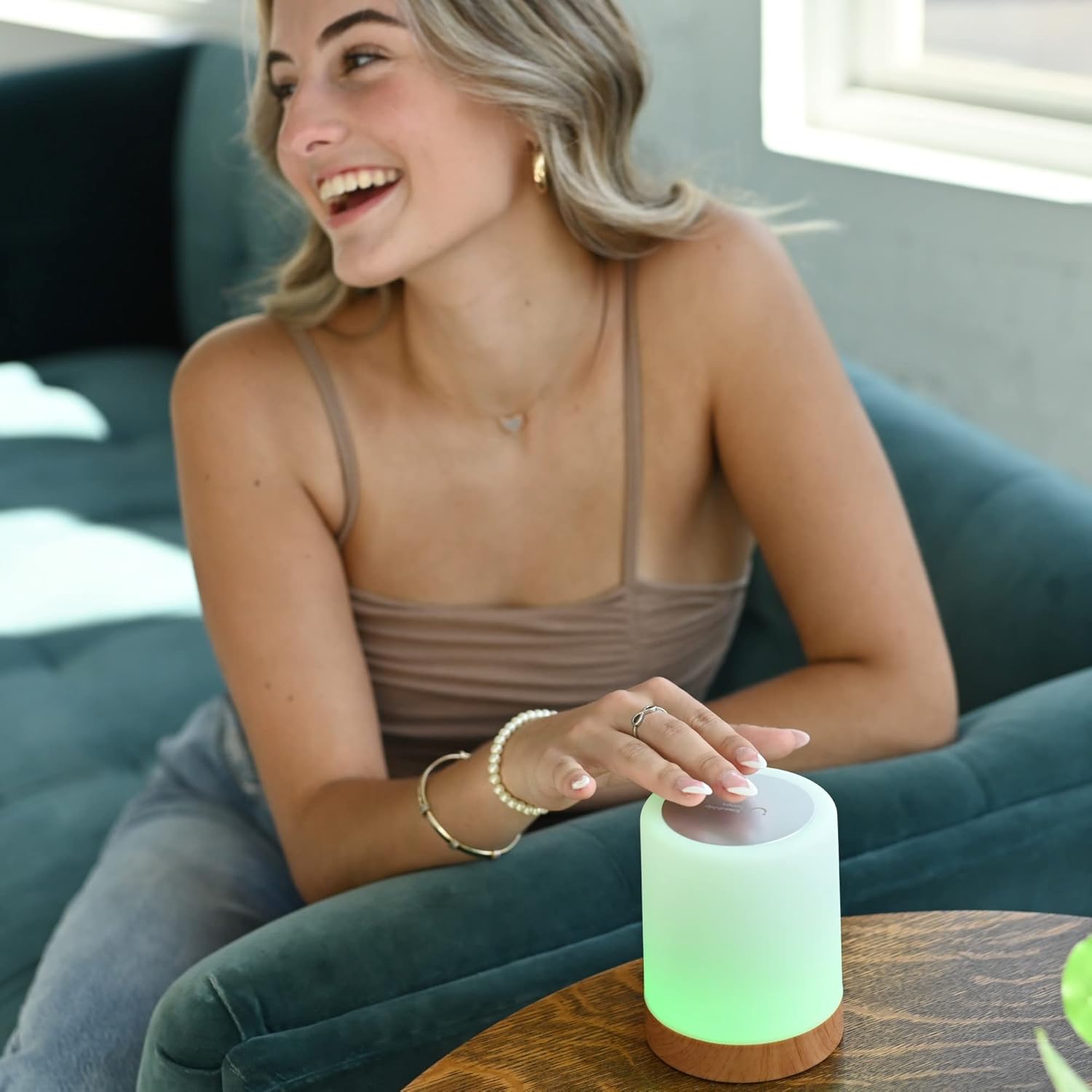 Friendship Lamp in a home office, glowing purple, with the app open on a phone